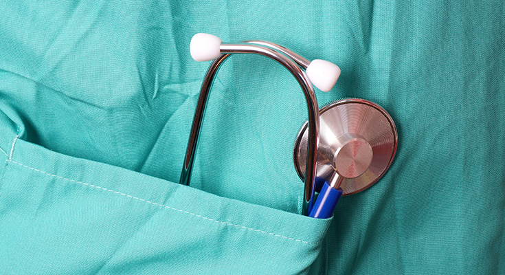 Close-up of stethoscope in shirt pocket of someone's scrubs