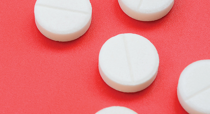 Close-up of small, white prescription pills