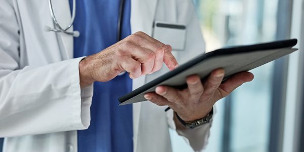 Close-up of physician using iPad