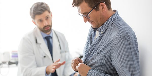 A doctor that appears to be trying to advise a patient against something