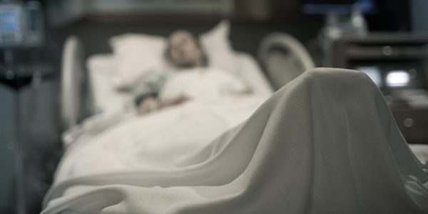 Unfocused photo of person in a hospital bed