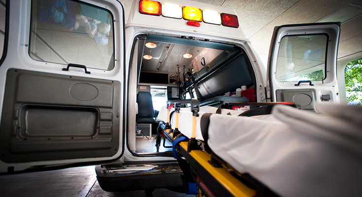 A gurney at the back entrance of an ambulance