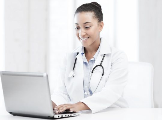 A physician using a laptop