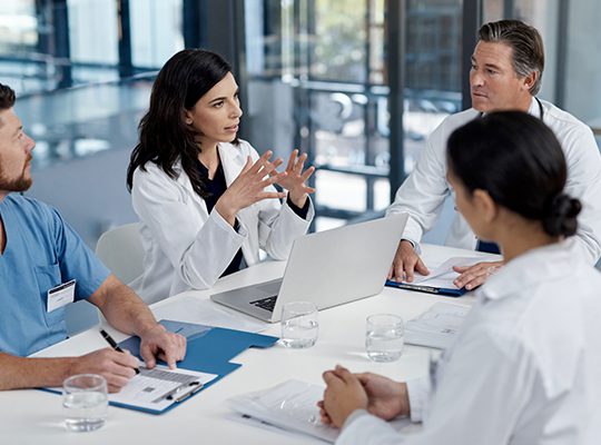 Physicians meeting around a table