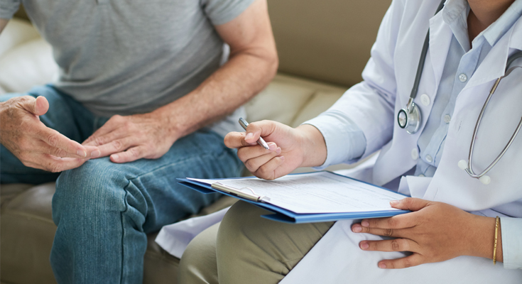 A physician consults with a patient.