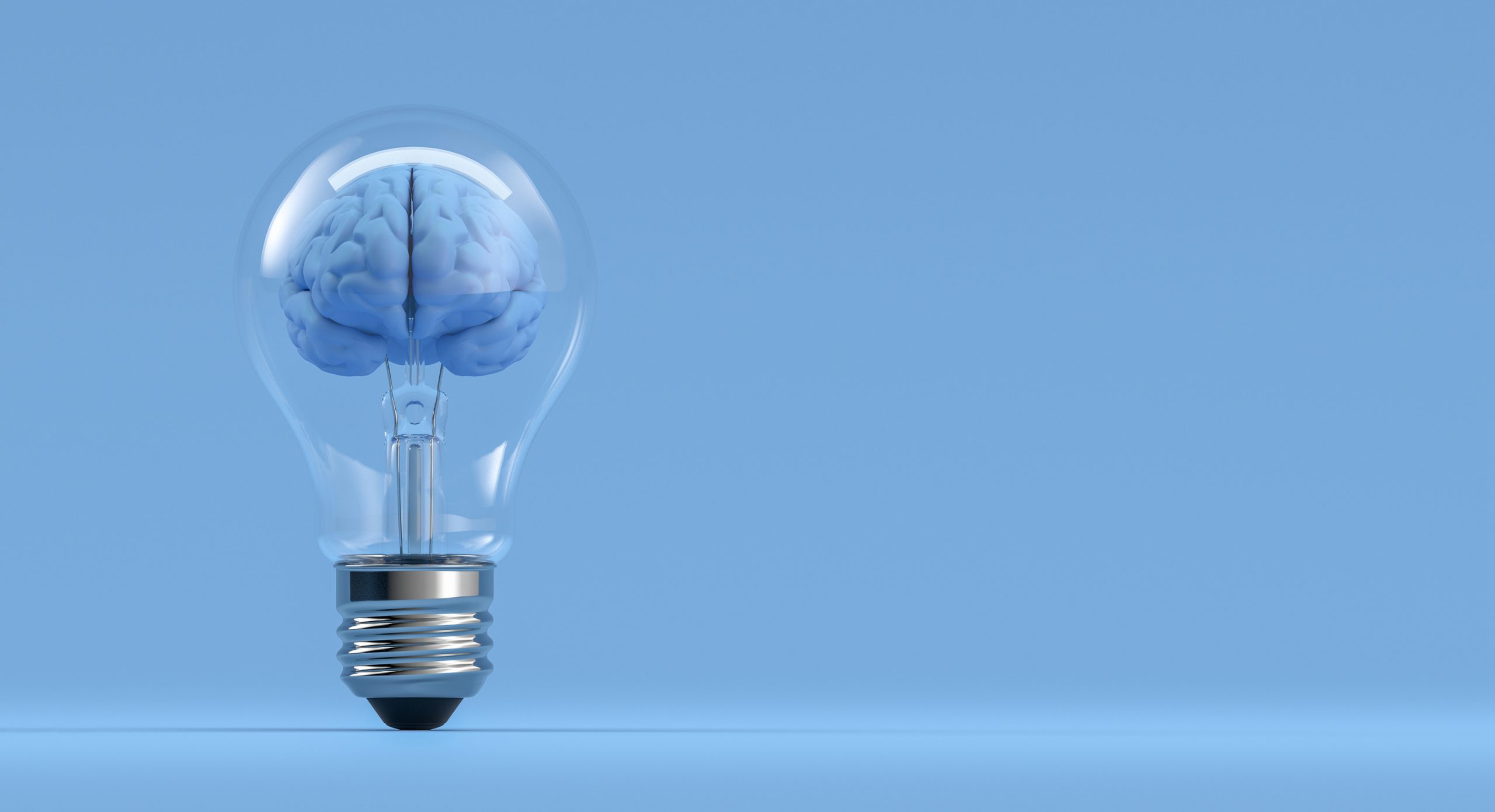 An image of a lightbulb with a brain inside against a blue background.