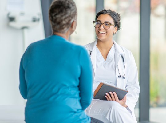 A physician conversing with a patient.